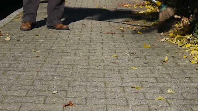 Male  Sweeping Street with Broom