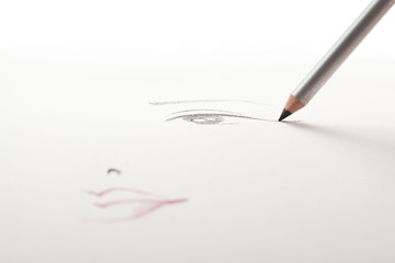 a make-up sketch, with a black eye liner pencil drawing the eye.