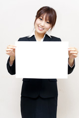 a portrait of young business woman taking a blank white board