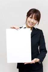 a portrait of young business woman taking a blank white board