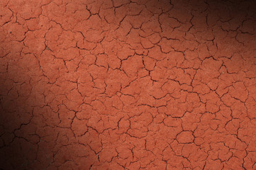 Cracked red textured surface lit diagonally