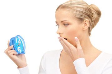 woman holding alarm clock