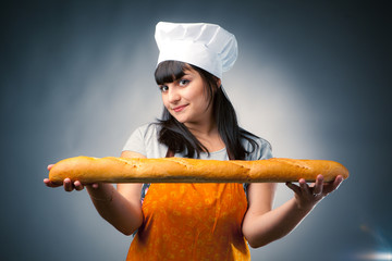 woman cook holding french bread