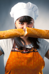 woman cook breaking a french bread