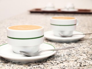 2 cups of coffee, on stone table