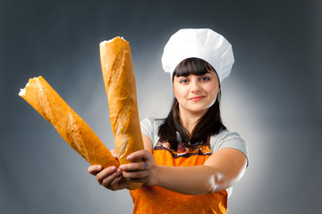 woman cook holding breaked french bread