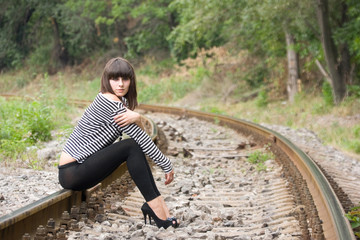 Young woman posing on the rails