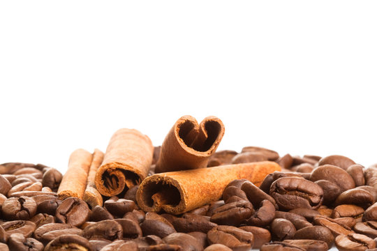 Cinnamon sticks over coffee beans