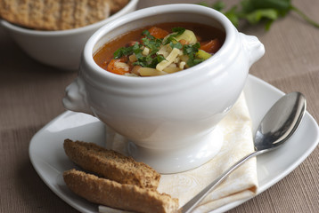 Bacon, bean and pasta soup in a bowl