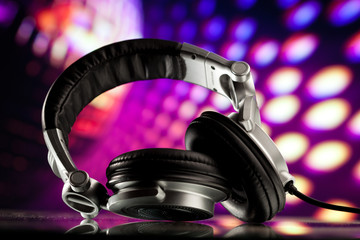 dj headphones against purple disco background