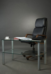Leather armchairs and glass table at office