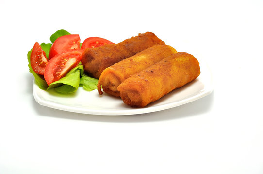 Polish Cuisine. Croquette and tomato on white plate.
