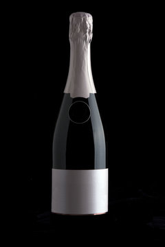 Champagne bottle isolated against a black background