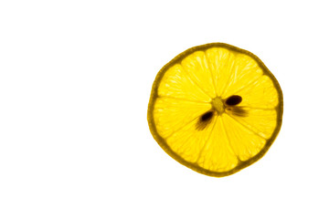A slice of lemon backlit on a white background