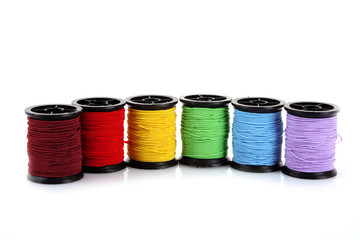 Coloured bobbins of thread isolated on white