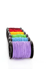 Coloured bobbins of thread isolated on white