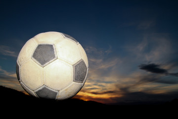 Fototapeta premium soccer ball in sunset