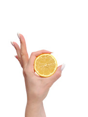 Lemon slice in a female hand, isolated on white