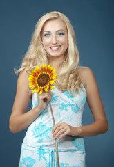 The beautiful girl with a sunflower