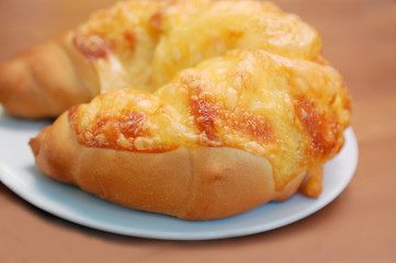 a breakfast croissant with cheese on a saucer