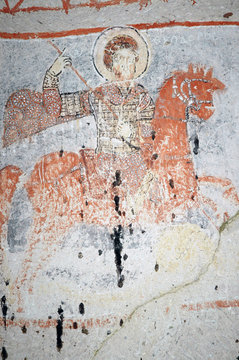 Ancient fresco in Cappadocia. Saint George killing the dragon