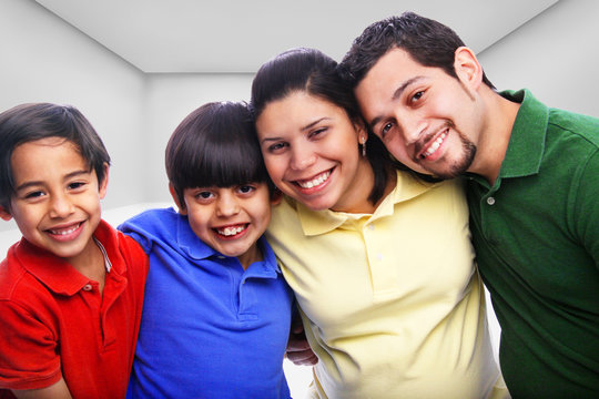 Family embracing in multi-color shirts