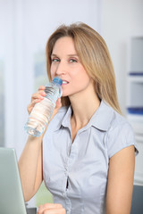 Closeup of beautiful office worker drinking water