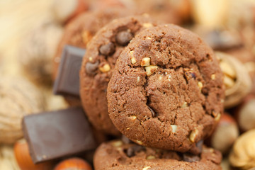 oatmeal cookies, chocolate and nuts on a wicker mat