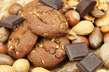 oatmeal cookies, chocolate and nuts on a wicker mat