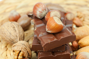 bar of chocolate and nuts on a wicker mat