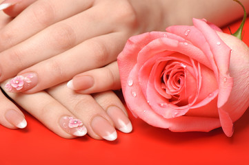 Obraz na płótnie Canvas Manicure. Female hands on red background