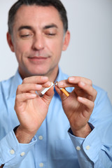 Closeup of man trying to quit smoking