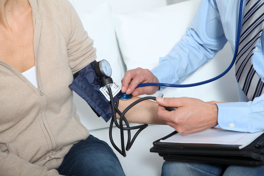 Doctor measuring blood pressure
