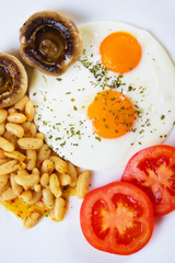 Fried eggs with mushrooms, beans and tomato