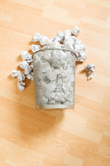 Fototapeta na wymiar Garbage bin with paper waste isolated on white