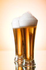 Beer glasses against the colorful gradient background