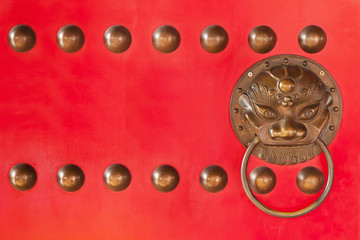 Decorated dragon on red door in Chinese temple,Thailand