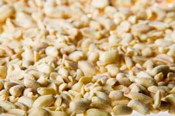 Handful of salted peanuts on a white background