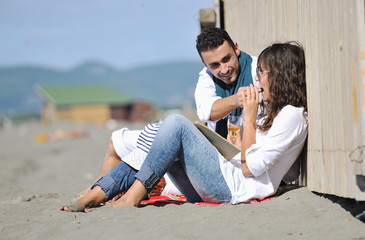 young couple enjoying  picnic on the beach