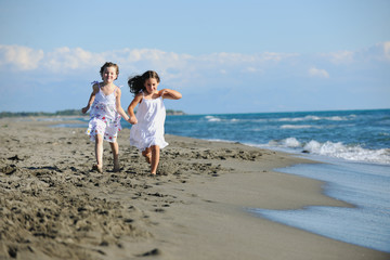 cute little girls running on beach