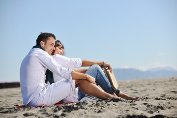 young couple enjoying  picnic on the beach