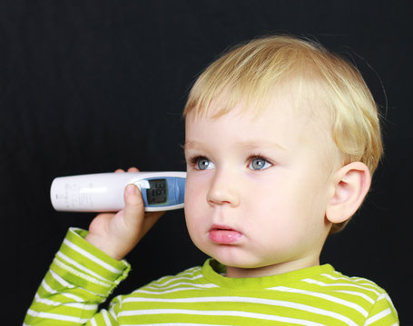 Baby boy and digital thermometer
