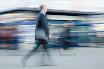 Motion blurred businessman rushing to office