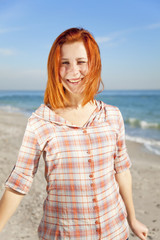 Pretty red-haired girl at the beach.