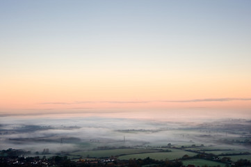 Fog covered English countryside at sunrise
