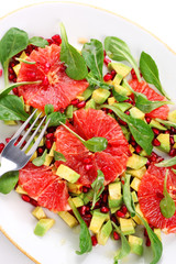 Fresh salad with grapefruit, avocado and pomegranate seeds