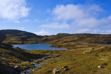 Fototapeta na wymiar Mountain lake on the ridge Musta Tunturi