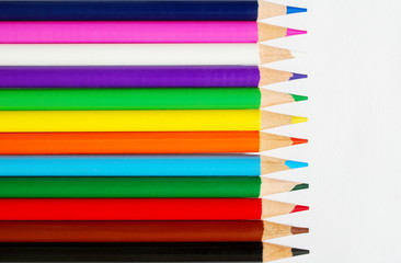 Line of pencils on white paper