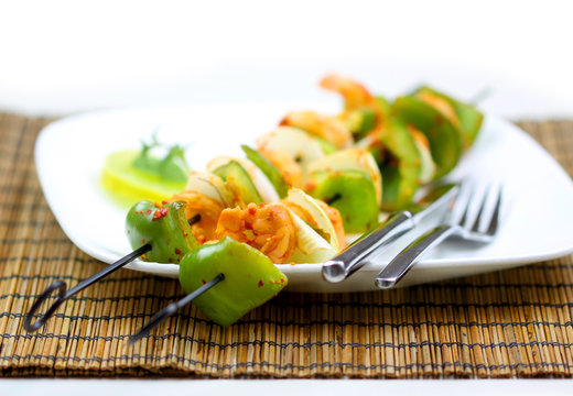 Grilled Shrimp And Vegetable Skewers On Plate