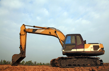 Excavator Loader with backhoe standing in sandpit
